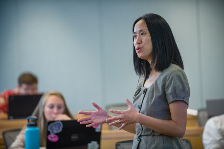 Jing Wang teaches students in a class