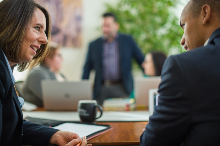 Two students work together in an MBA class at UNH's Paul College