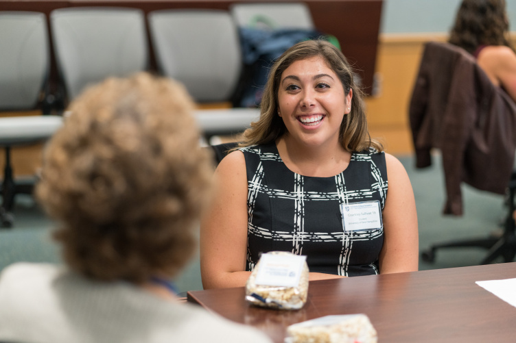 Female student smiles as she interacts with mentor at Paul College mentoring event