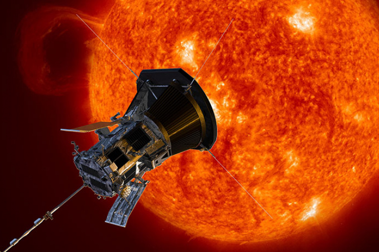 A silver octagonal probe approaches the red-hot surface of the sun.