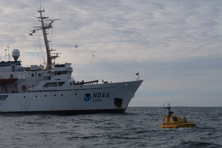 Photo of the ship from a voyage that deployed the first autonomous (robotic) surface vessel — the Bathymetric Explorer and Navigator (BEN) — far above the Arctic Circle.