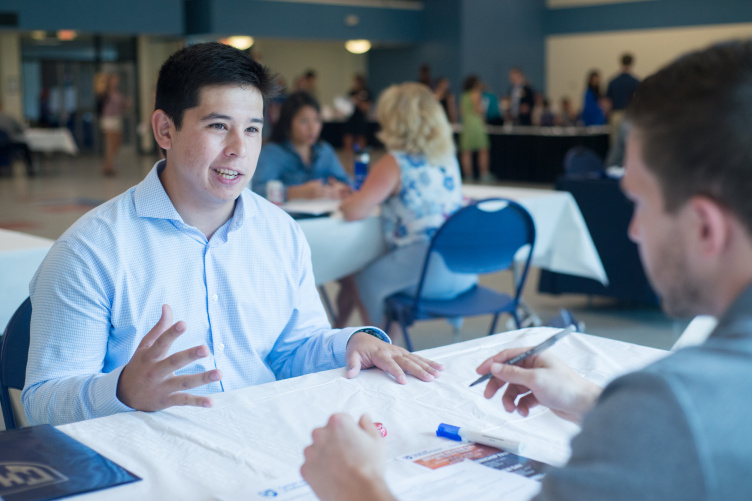 student speaking with employer