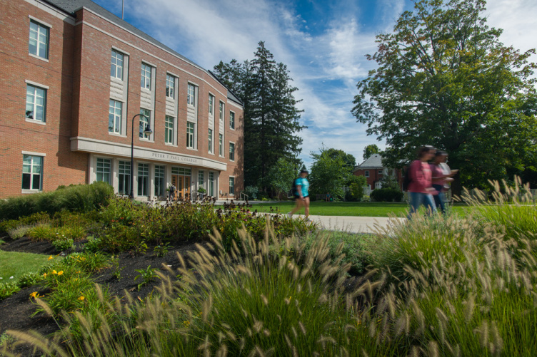 Paul College exterior view with students walking