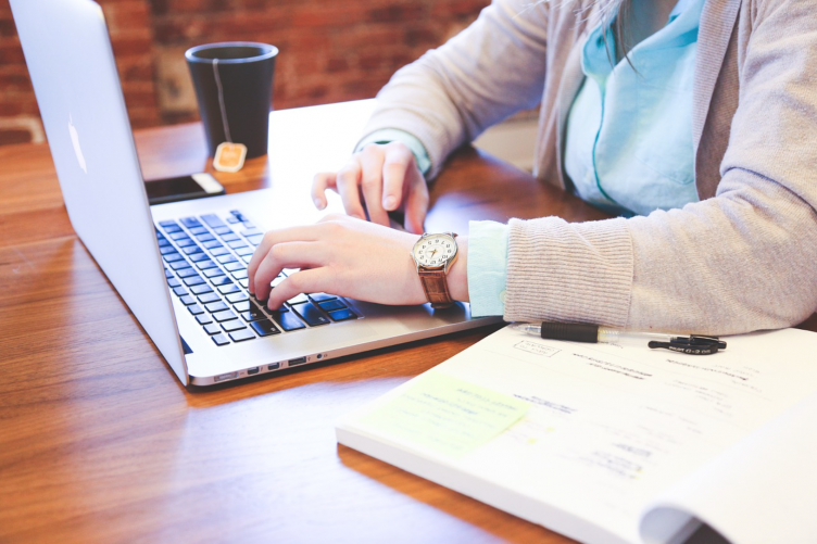 Woman working on her laptop at a coffee shop