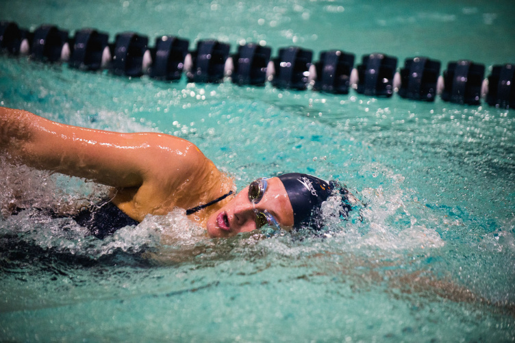 A UNH swimmer in the pool at the 2018 America East Championship