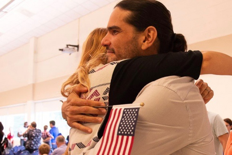 New U.S. citizens embrace after swearing in ceremony