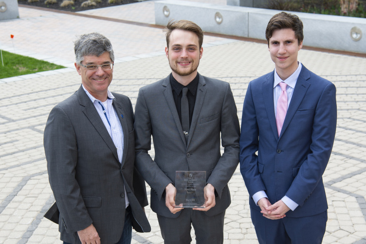 YouScheduler teammates Kristian Comer and Francesco Mikulis-Borsoi pose with their faculty advisor, Ian Grant.