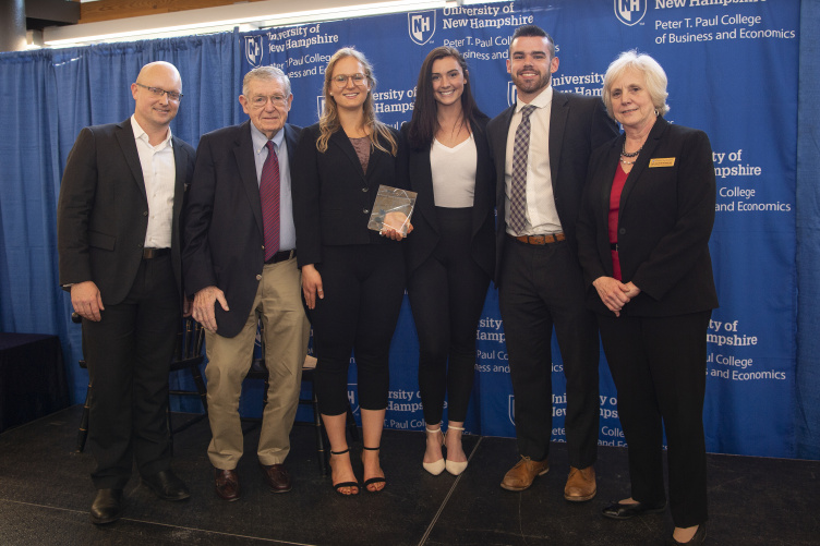 Winning team poses with competition director, dean, and benefactor