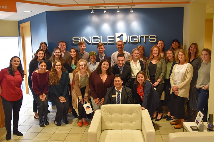 group of students in front of Single Digits sign