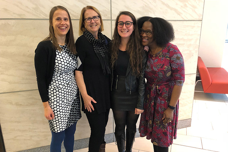 photo of four women at conference