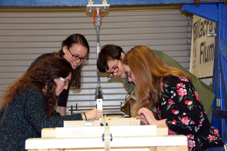 UNH professor Nancy Kinner and students at work in a lab