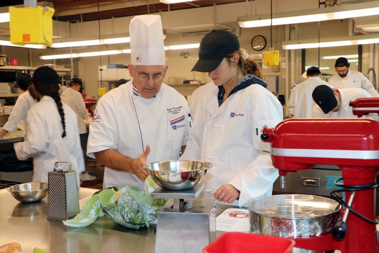 Professor Charlie Caramihalis instructs a student in the new Culinary Nutrition and Food Studies minor