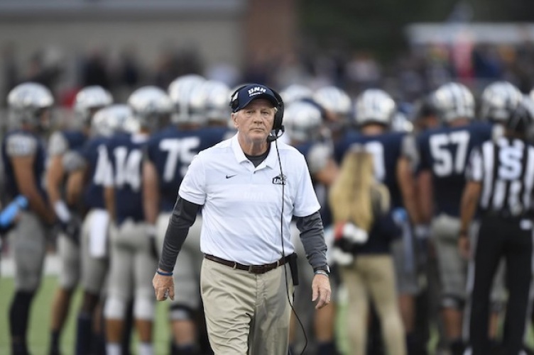 Head football coach Sean McDonnell walking on the field.