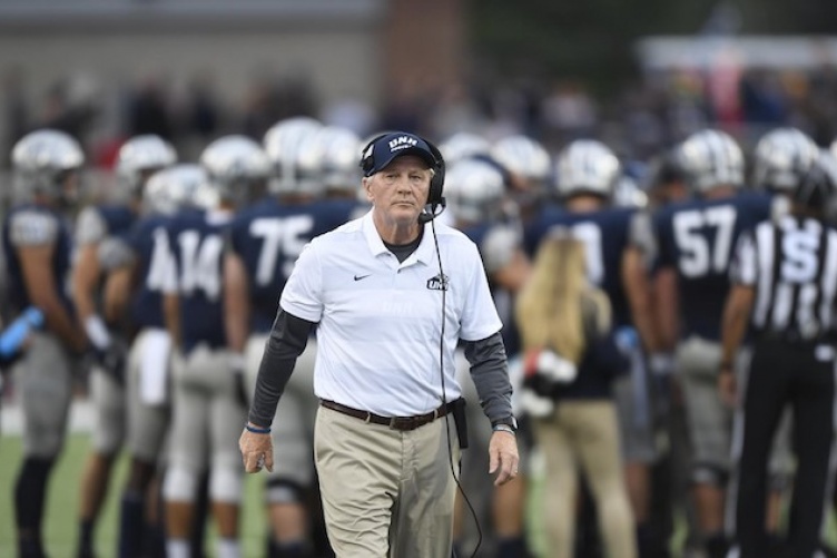 Head football coach Sean McDonnell  walking on the field.