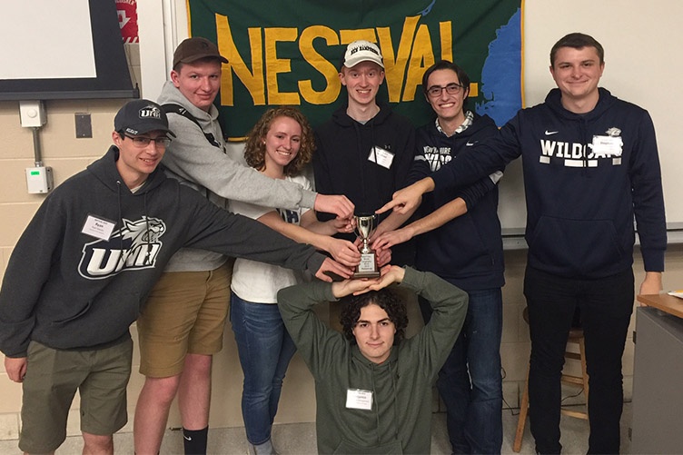 students posing with trophy