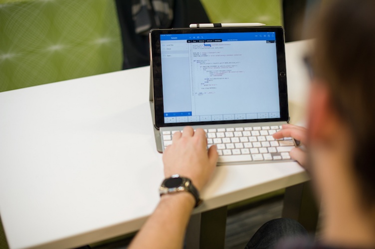 Image of student on a laptop coding 