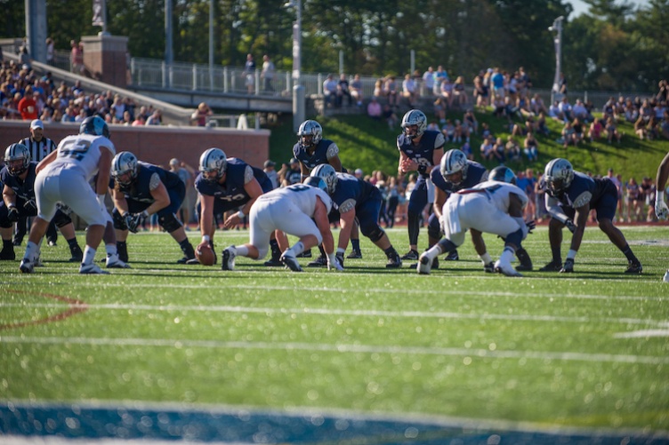 UNH football team on field 