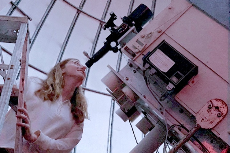 Morgan Saidel looking through telescope at Cornell University