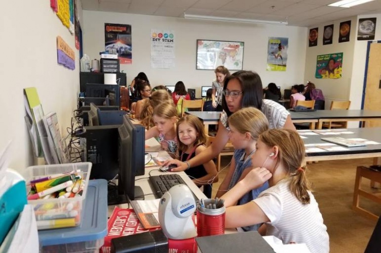 Past Aspirations in Computing Award recipient helps with a girls’ coding program.