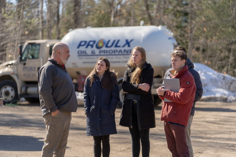 Proulx Oil representative talking with Paul College students in front of Proulx truck