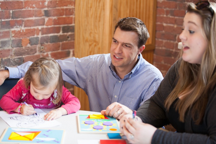 Psychology professor Nick Mian working with student and child in child psychology lab at UNH Manchester