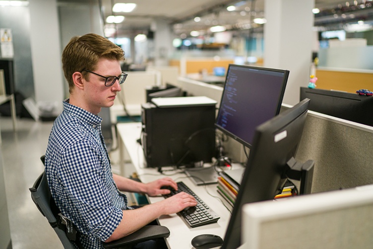 Student at desk in cybersecurity program