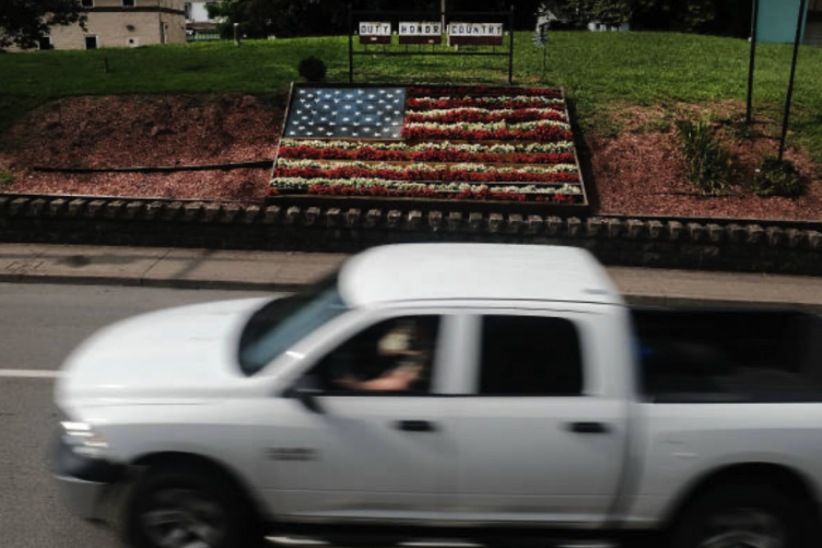 White pickup truck drives on a rural town in America White pickup truck drives on a rural town in America