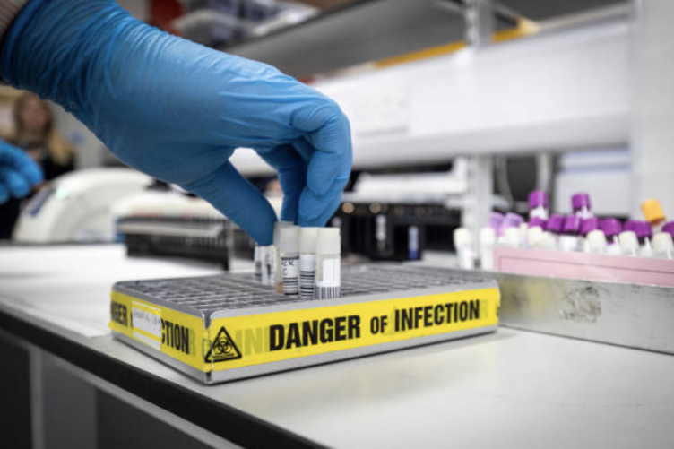Image of a person testing COVID-19 samples Image of a person testing COVID-19 samples