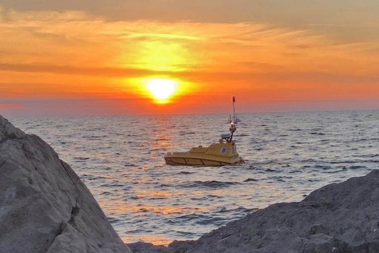 Autonomous boat under a dramatic sunrise