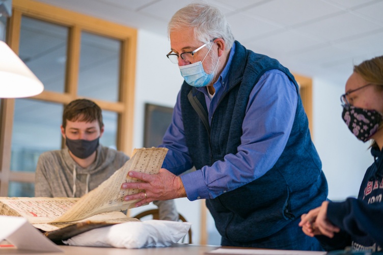 Bill Ross showing archival collection book