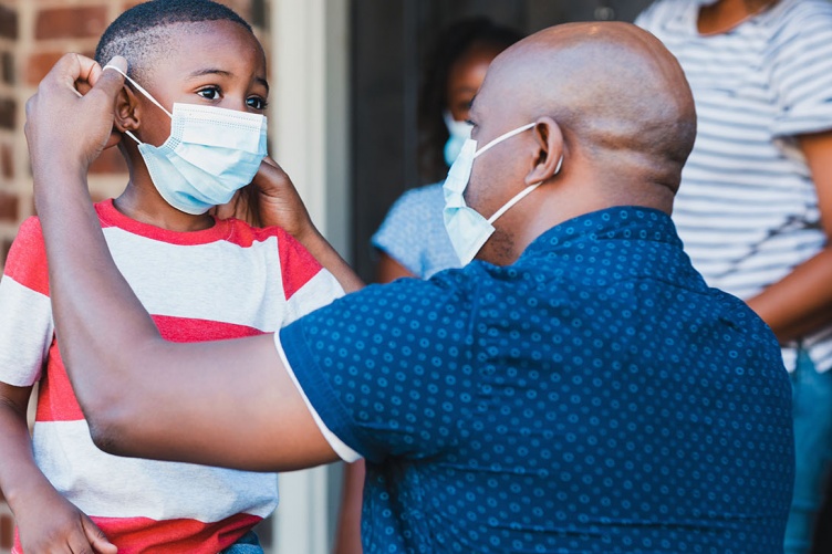 Image of Black American man and son with masks