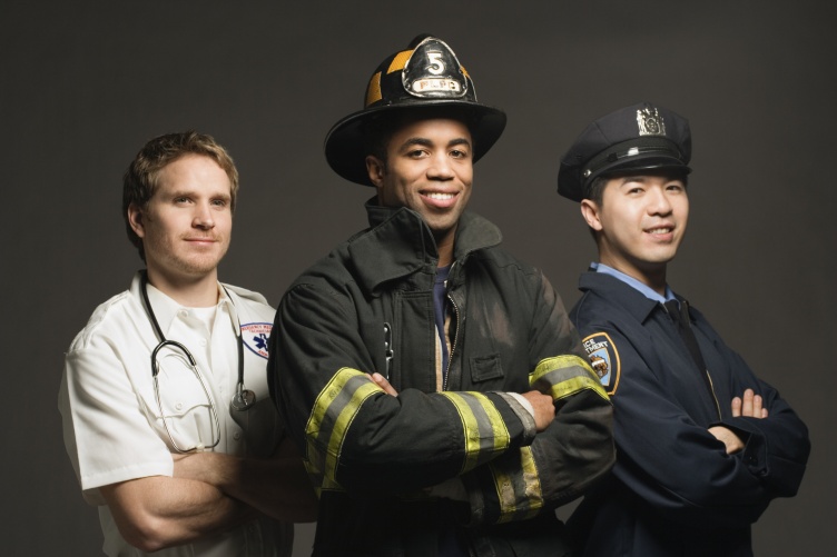 A photo of three first responders: An emergency medical technician, a firefighter, and a police officer