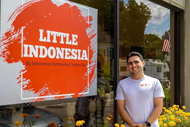 student standing outside Little Indonesia storefront in Somersworth