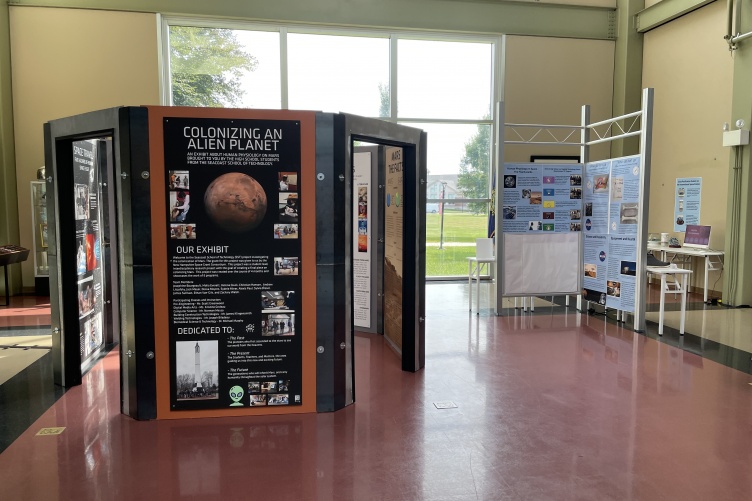 Two exhibits featuring posters and computer kiosks at a museum.