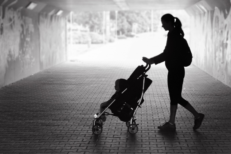 Image of Women Walking Baby in a Stroller