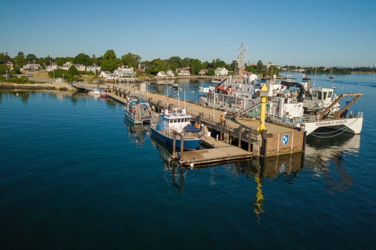 UNH pier with research vessels on either side of it.