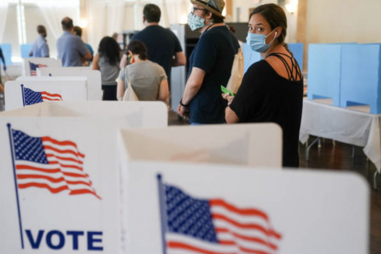 People wait in line to vote. 