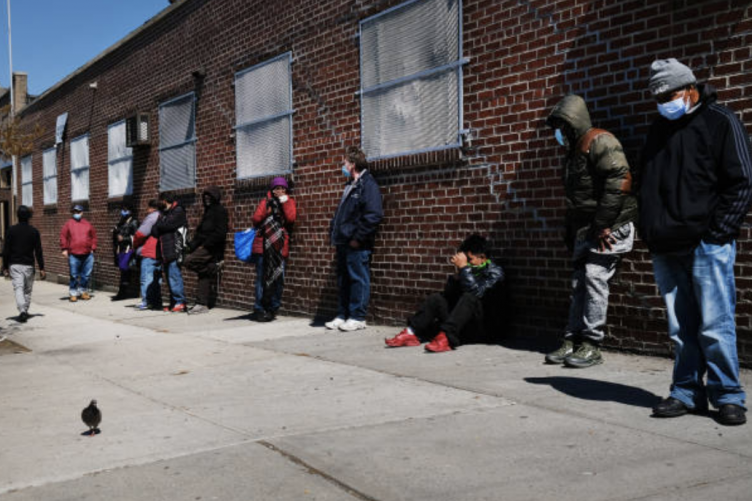 People wait in line to receive assistance 