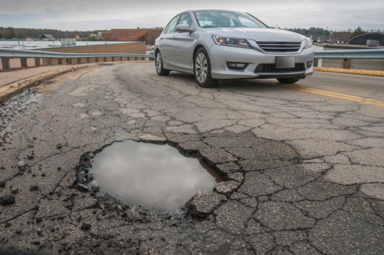 car near pothole