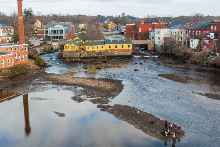 Aerial view of river with researchers working on sandbar