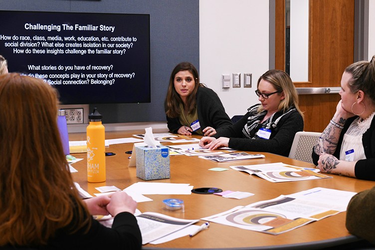 students participating in dialogue around a table