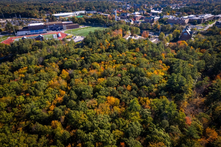 aerial photo of UNH College Woods in fall with football stadium in background