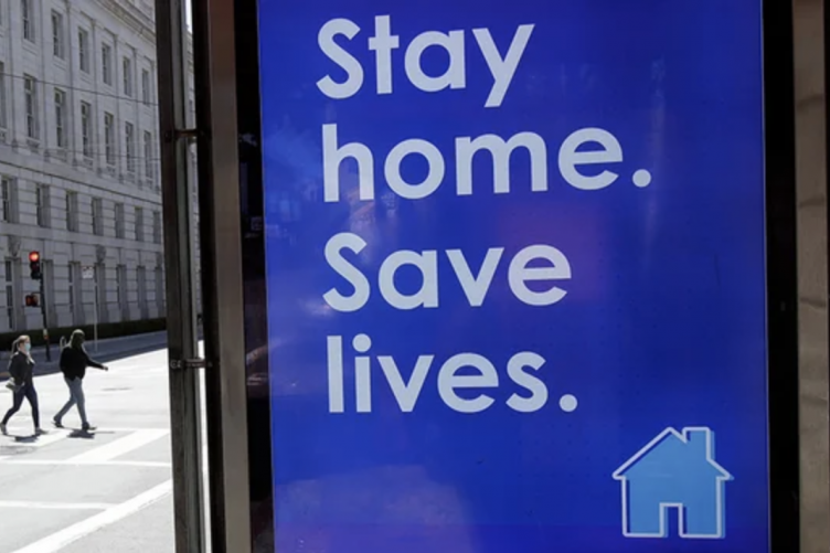 Image with sign staying Stay Home. Save Lives.