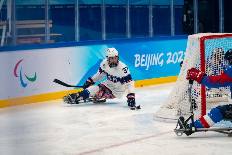 Sled hockey player behind goal