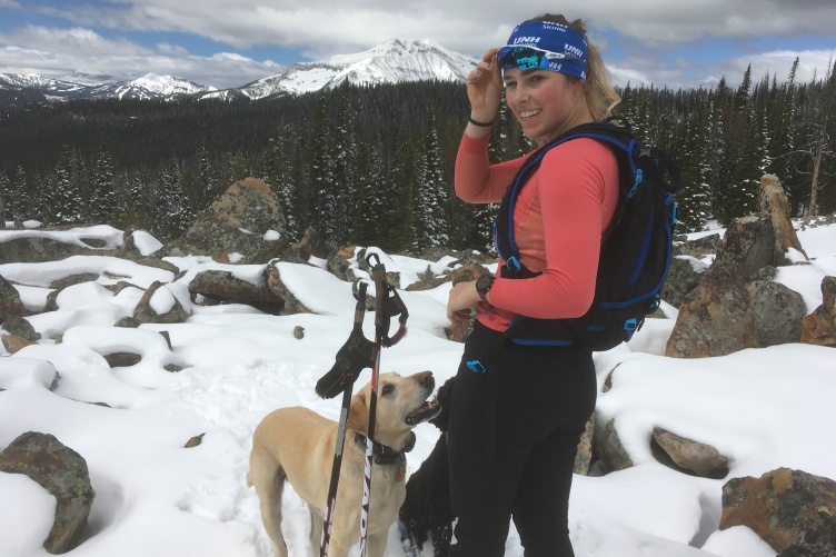 UNH student Georgi Fischer cross country skiing with her dog