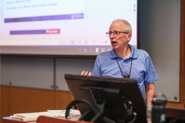 Roger Grinde gives a presentation at the 2023 University of New Hampshire Faculty Excellence Awards.