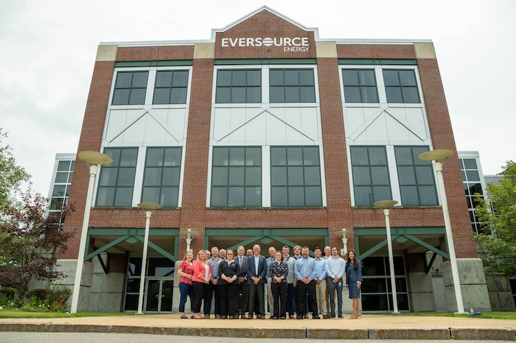 UNH graduates gather outside of Eversource in Manchester.