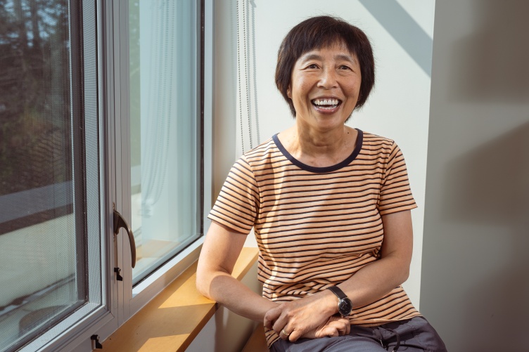Ju-Chin Huang sits by a window inside her office.