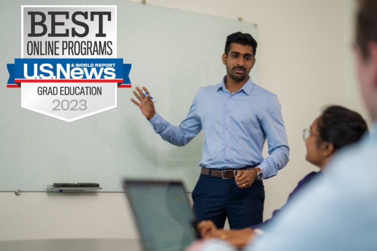 Image of student at front of class with US News Baged