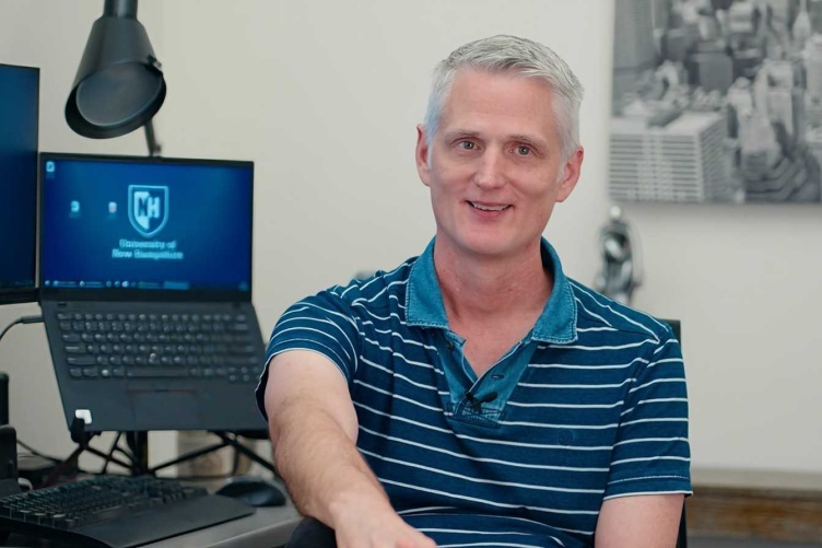 Russell Miles sits in office at the University of New Hampshire 